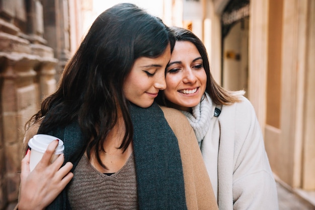 Amiche amorose che camminano sulla strada