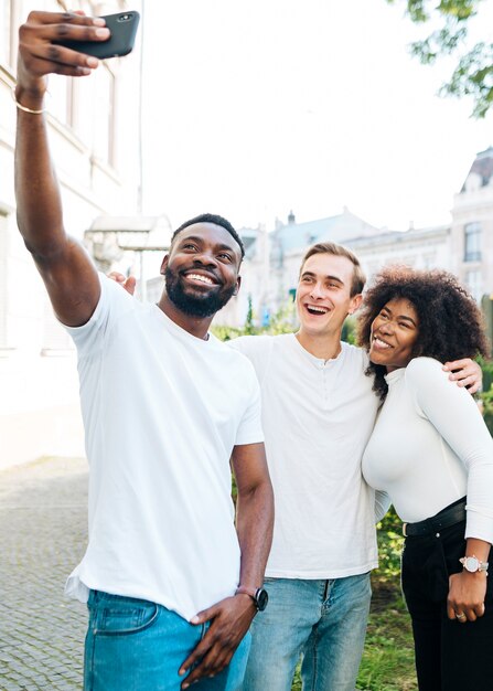 Amici all'aperto prendendo selfie insieme