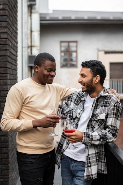 Amici che sorridono mentre tengono in mano un drink