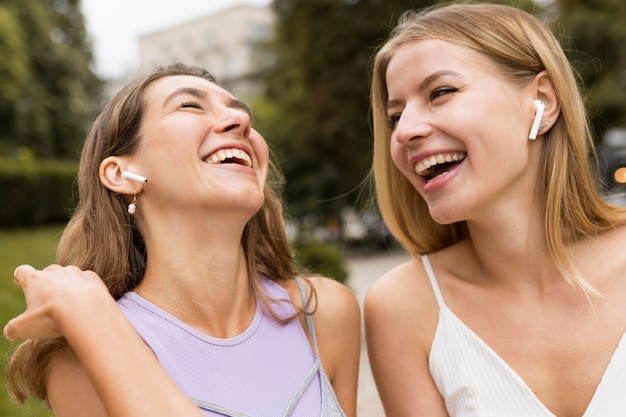 Amici del primo piano che ridono nel parco