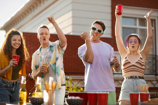 Amici di tiro medio che giocano a beer pong