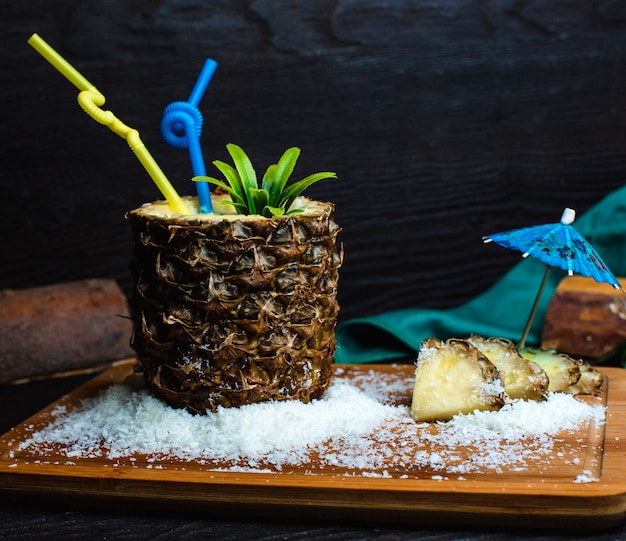 Ananas fresco su una tavola di legno con cocco