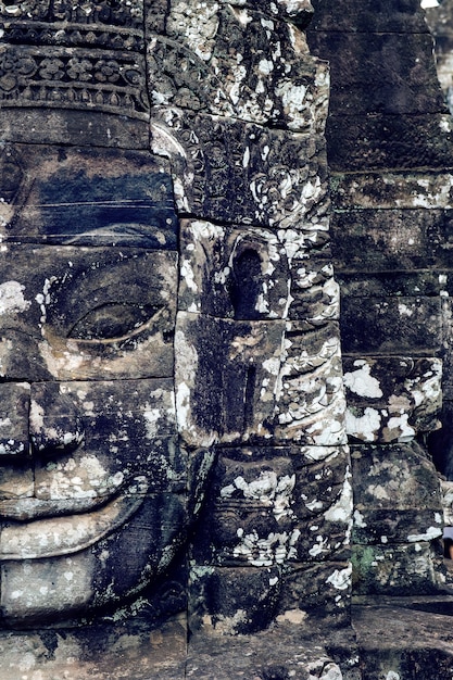 Antichi volti di pietra del tempio Bayon, Angkor Wat, Siam Reap, Cambogia.