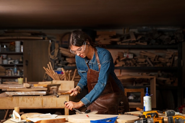 Artigiano di tiro medio che fa il taglio del legno