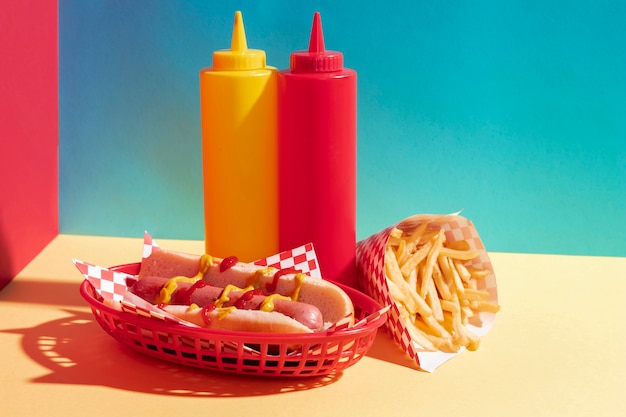 Assortimento di alimenti con hot dog e bottiglie di salsa
