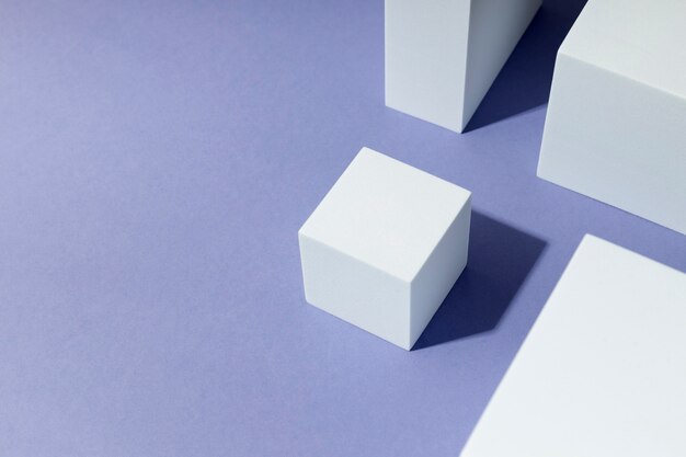 Assortimento di cubi bianchi ad alto angolo su sfondo viola
