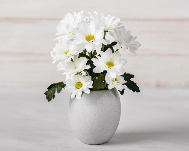 Assortimento di fiori bianchi in vaso bianco