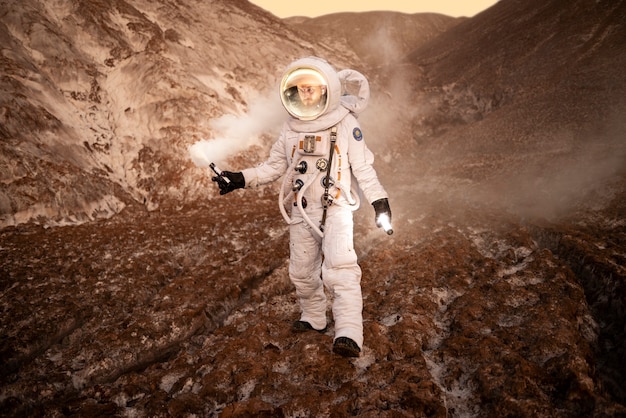 Astronauta maschio che segnala la sua posizione durante una missione spaziale su un pianeta sconosciuto