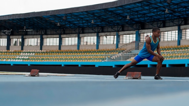 Atleta che si allunga allo stadio