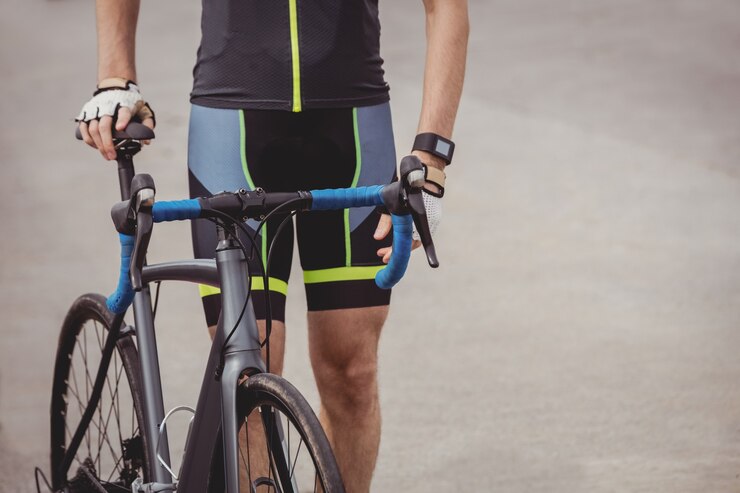 Foto gratuito atleta in piedi con la sua bicicletta