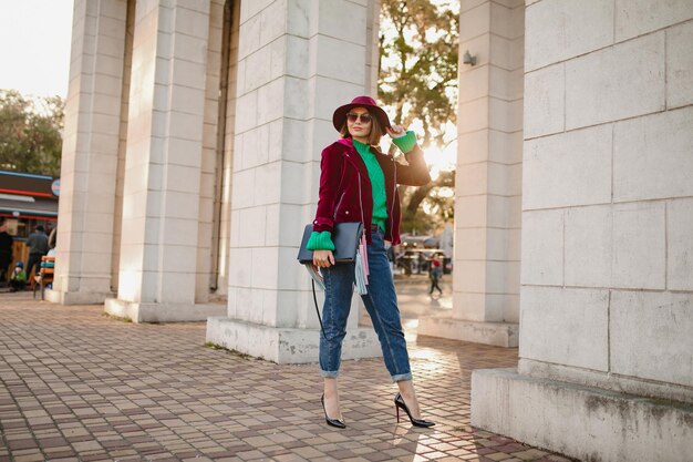 Attraente donna in abito alla moda stile autunnale che cammina in strada