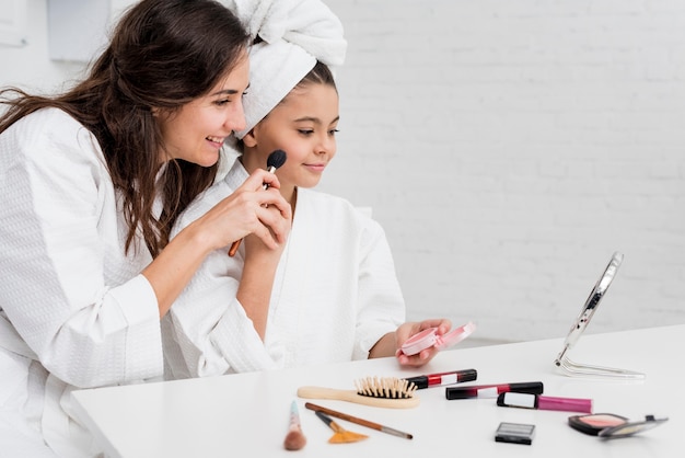 Bambina e madre che fanno il loro trucco