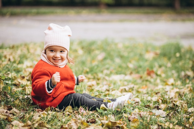 Bambina sveglia in un parco in autunno