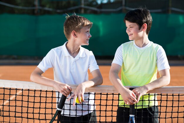 Bambini a tiro medio sul campo da tennis