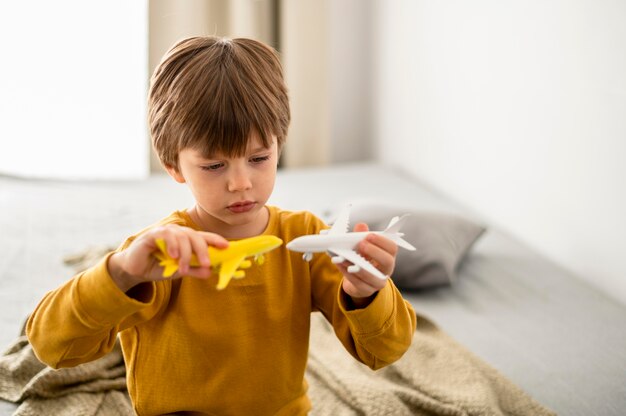 Bambino che gioca con le figurine dell'aeroplano