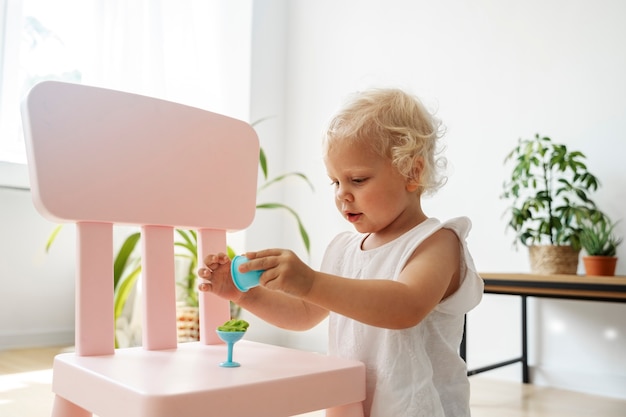 Bambino di vista laterale che gioca con i giocattoli