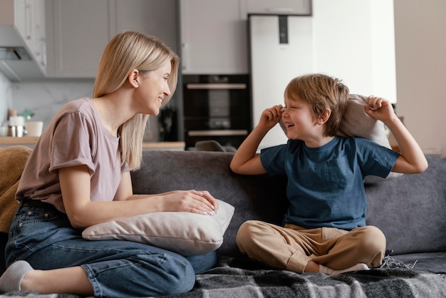 Bambino e madre del colpo pieno sul divano