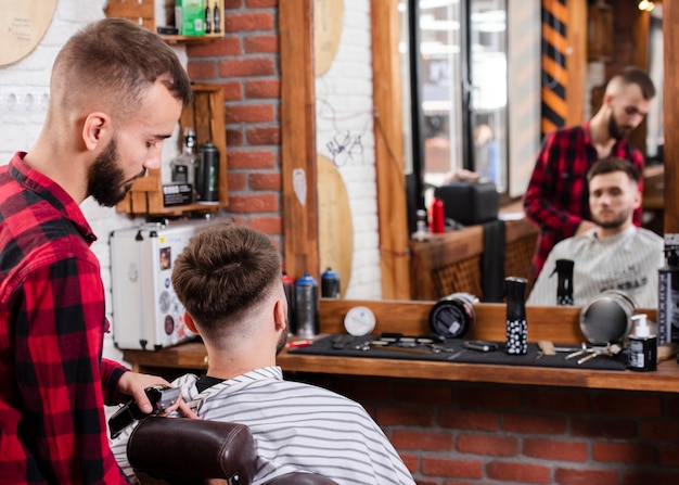 Barbiere che mostra il taglio di capelli al cliente