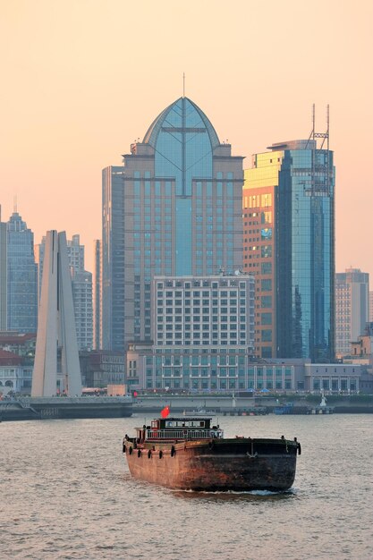 Barca nel fiume Huangpu con architettura urbana di Shanghai