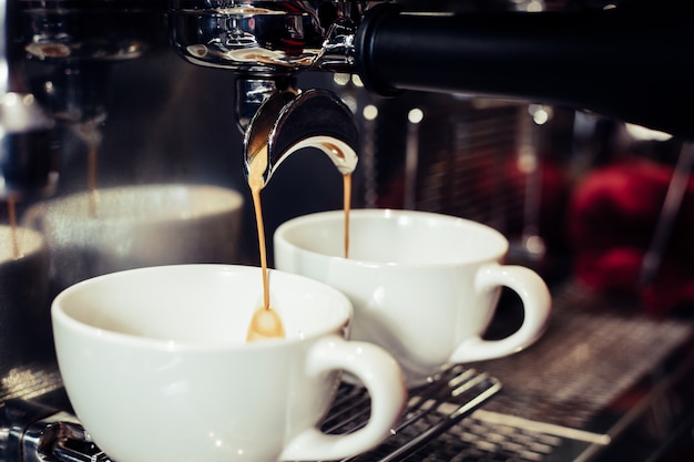 Barista utilizzando la macchina per il caffè nella caffetteria.