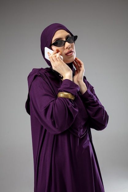 Bella donna araba in posa in elegante hijab isolato su studio. Concetto di moda