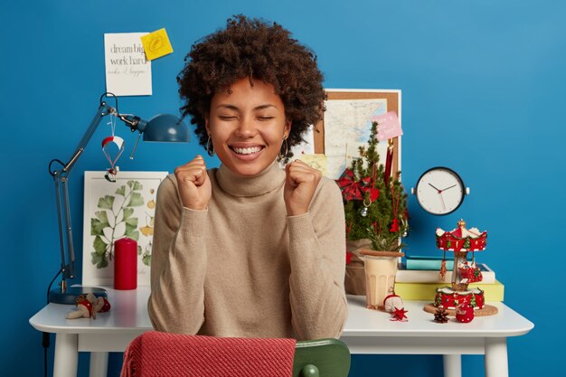 Bella donna castana che rimane nel suo posto di lavoro