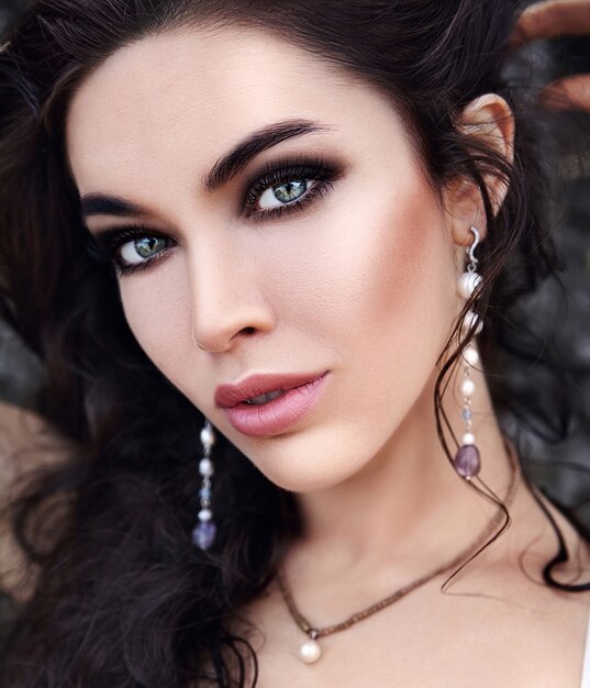 bella donna caucasica con trucco sera e capelli lunghi scuri all'aperto