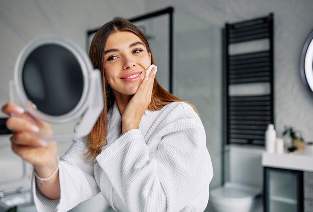 Bella donna che si prende cura del suo viso