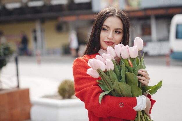 bella donna con fiori tulipani all'aperto