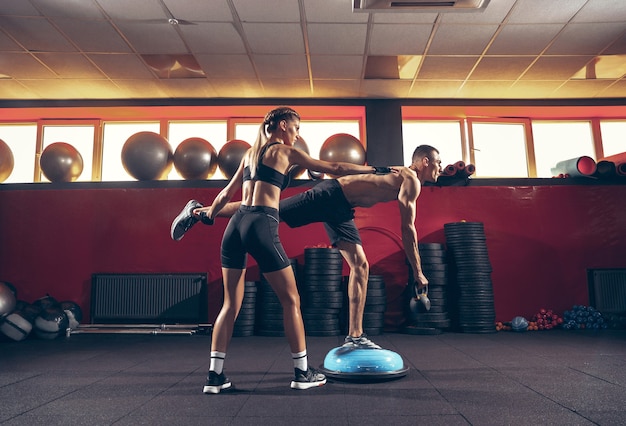 Bella giovane coppia sportiva allenamento allenamento in palestra insieme gym