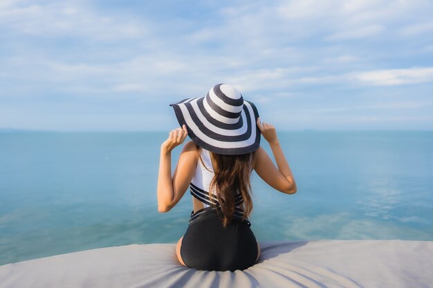 Bella giovane donna asiatica del ritratto intorno all'oceano della spiaggia del mare