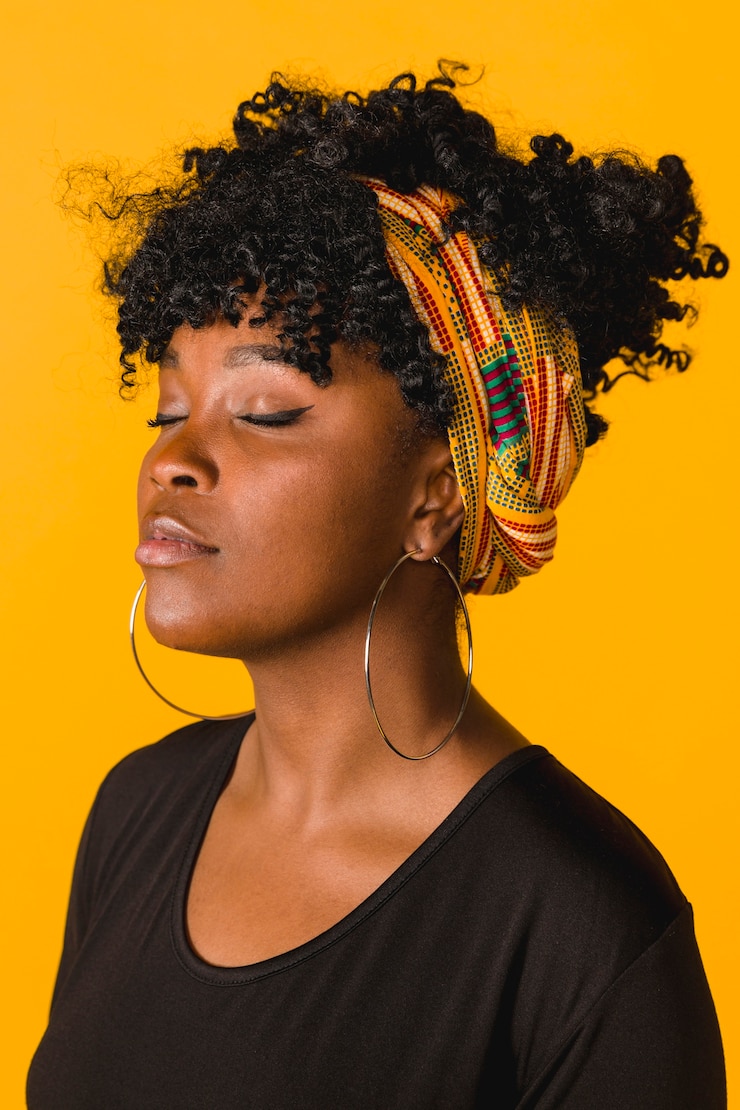 Foto gratuito bella giovane donna riccia africana su sfondo colorato