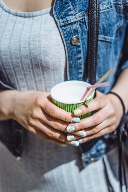 bella giovane donna riccia all&#39;aperto a camminare e bere caffè.