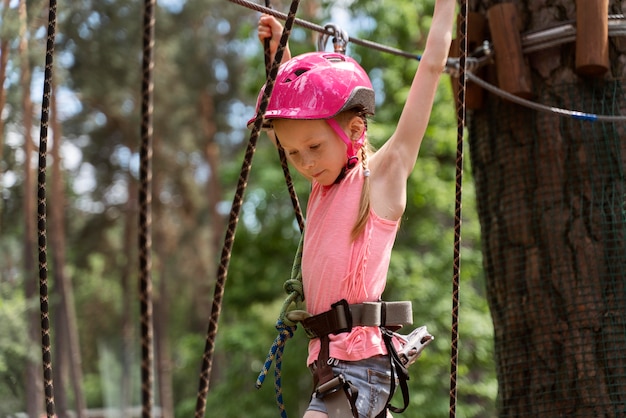 Bella ragazza che si diverte in un parco avventura