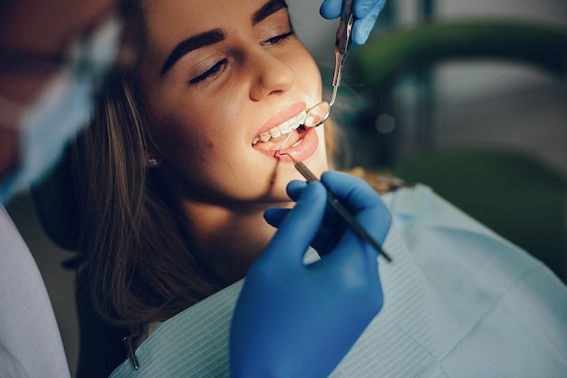 Bella ragazza che si siede nell&#39;ufficio del dentista