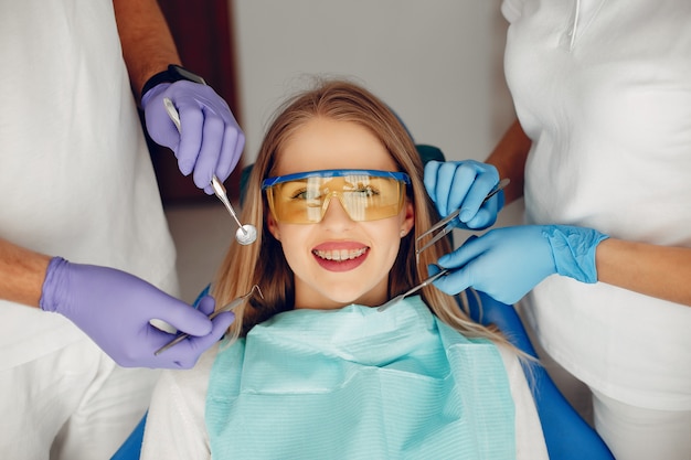 Bella ragazza che si siede nell&#39;ufficio del dentista