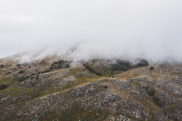 Bella ripresa di una montagna ricoperta di spesse nuvole bianche