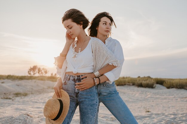 Belle donne alla moda in vacanza estiva sulla spiaggia, in stile bohémien, divertendosi