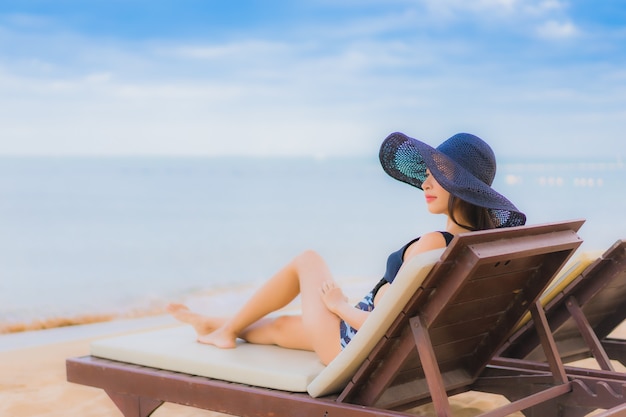 Belle giovani donne asiatiche del ritratto intorno all'oceano della spiaggia del mare