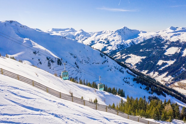 Bello scatto di una funivia in alte montagne innevate