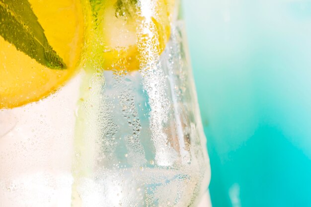 Bevanda fresca con fette di lime e menta in vetro ghiacciato