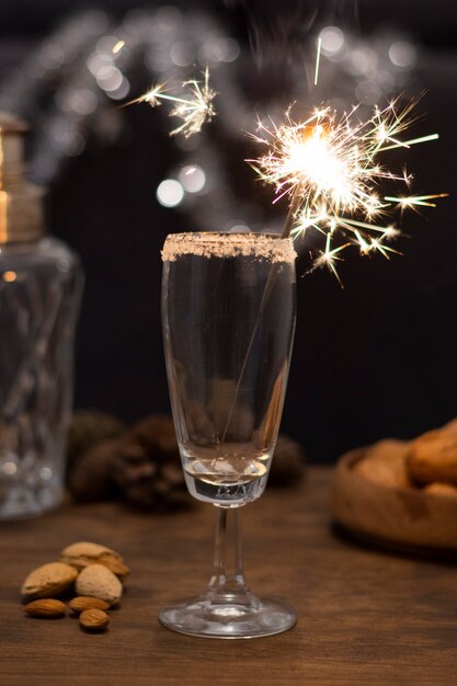 Bicchiere con champagne e fuochi d'artificio