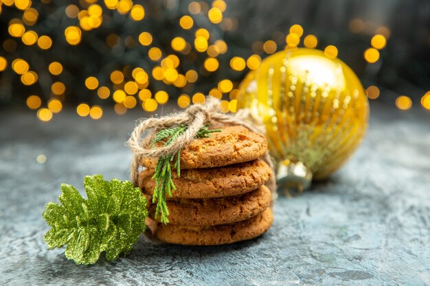 Biscotti vista frontale legati con corde ornamenti natalizi su sfondo grigio