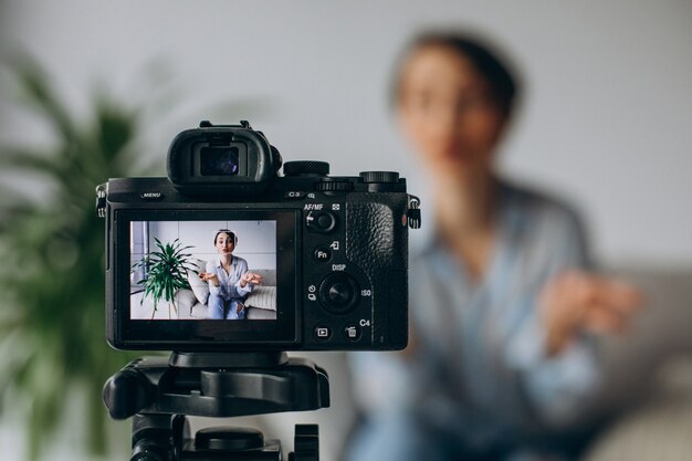 Blogger di giovane donna che registra video sulla fotocamera