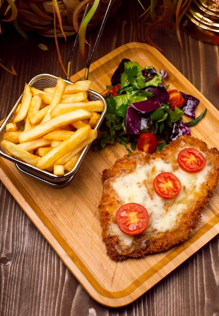 Bocconcini di pollo, patatine fritte. Pepite e patate fritte con insalata e formaggio fuso.