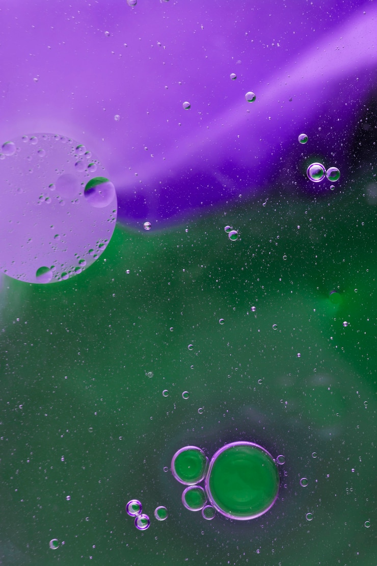 Foto gratuito bolle di olio che galleggiano sul fondo dell'acquerello verde e viola