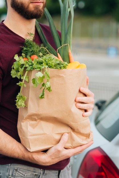 Borsa di drogheria della tenuta dell'uomo del primo piano