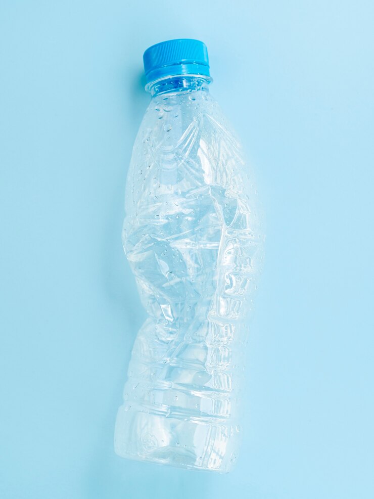Foto gratuito bottiglia di plastica su sfondo blu