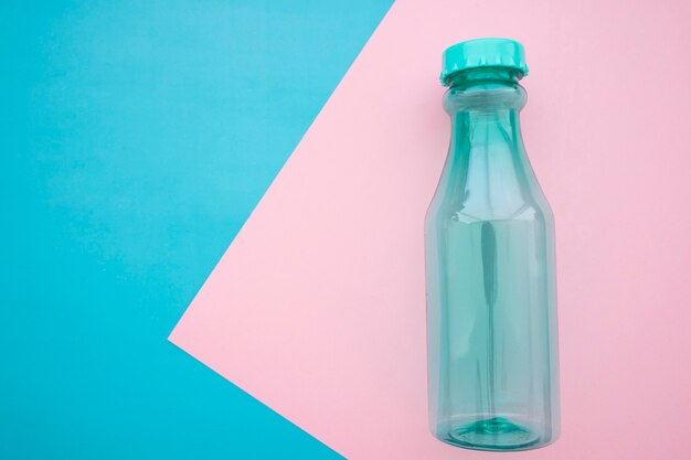 Bottiglia su sfondo blu e rosa