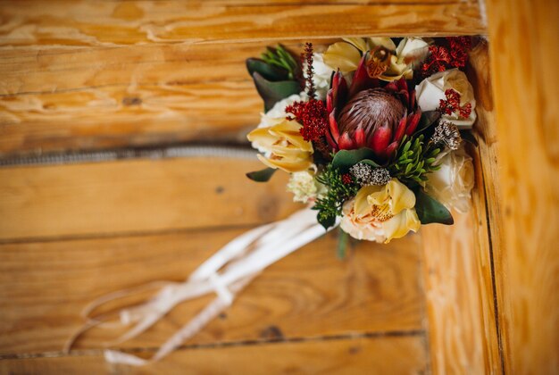 Bouquet da sposa fatto di fiori autunnali si leva in piedi sulla panchina